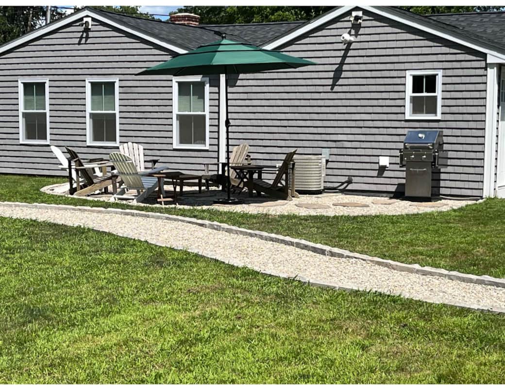 A SPACIOUS, PRIVATE PATIO WITH ADIRONDACK CHAIRS TO LOUNGE PLUS A GAS GRILL