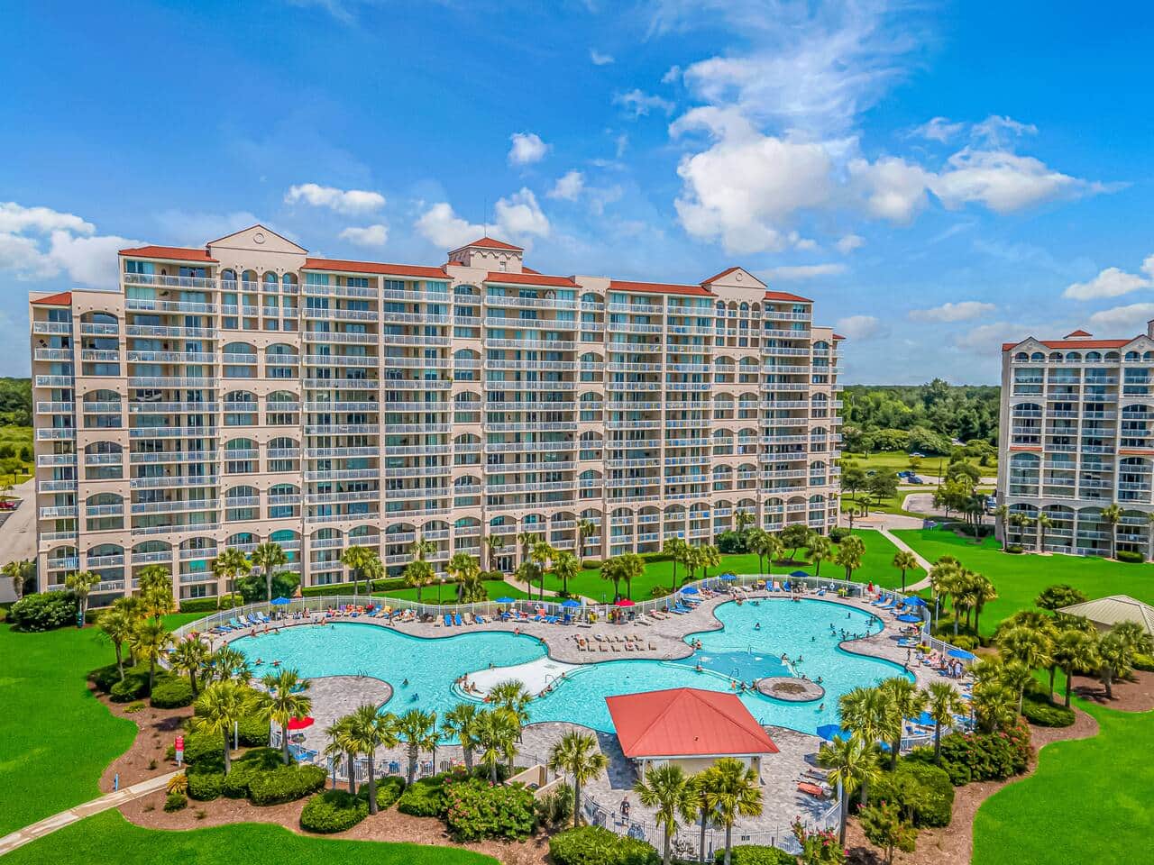 Luxury Resort Living
Stunning pool complex surrounded by beautifully maintained resort buildings and tropical landscaping.
