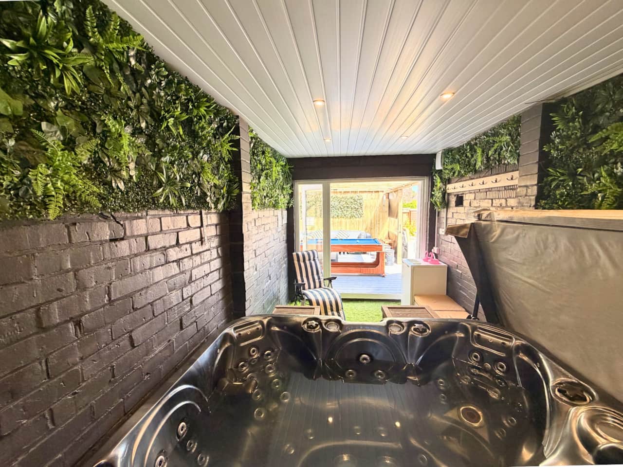 All weather seating area + pool table + hot tub room
