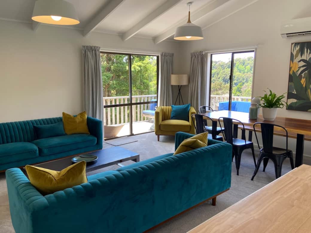 Lounge opens directly onto the wrap-around deck — indoor outdoor living