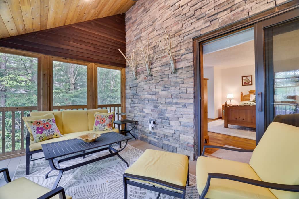 Stone and cedar screened porch facing the lake