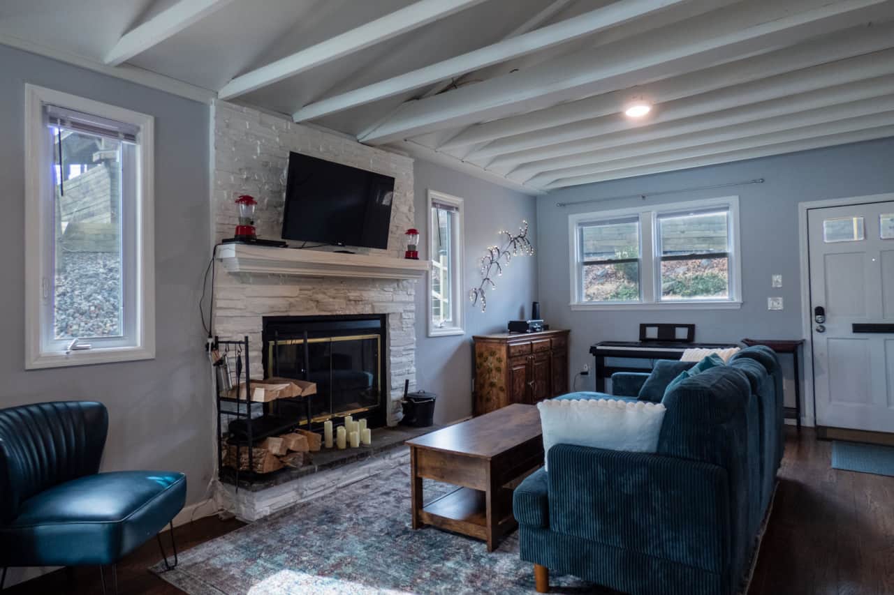 Cozy gathering areas in the living room around the fireplace or next to the keyboard.