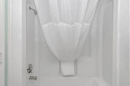 Clean and refreshed bathroom with a full shower/tub combo.