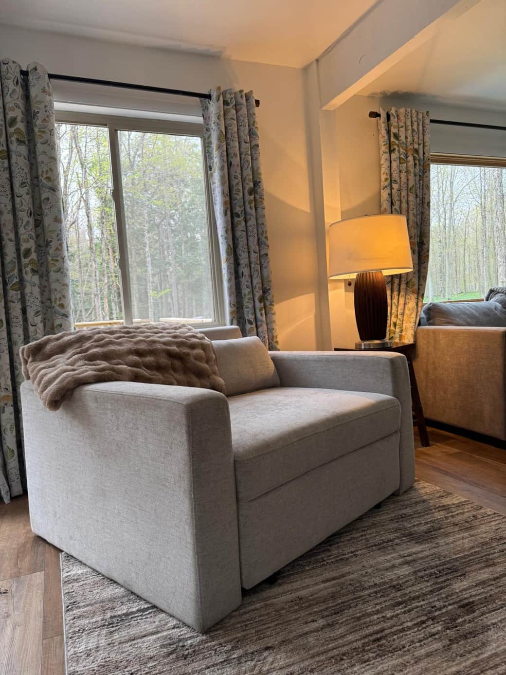 A comfy sleeper chair invites for reading and watching TV downstairs in the living room area.
