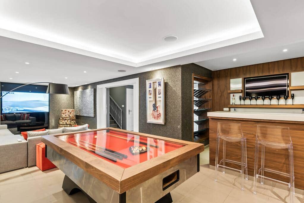 The downstairs area with bar, pool table. and cinema.