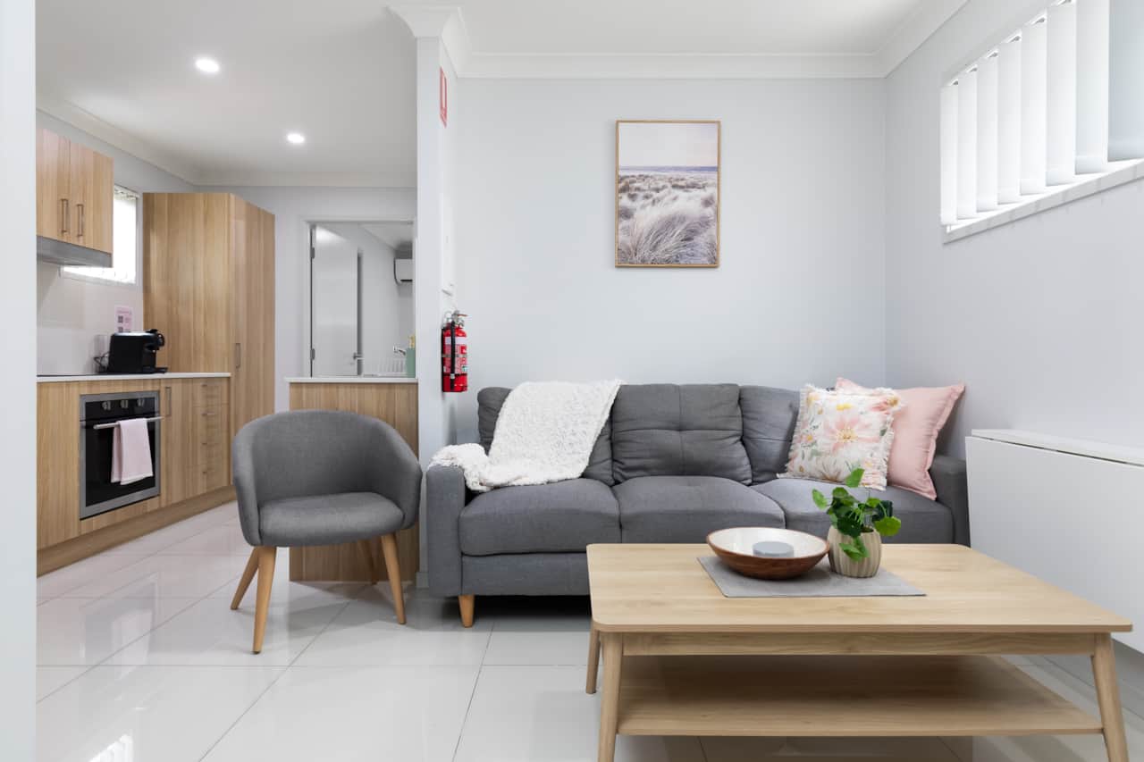 Living Area: Bright living space with comfortable seating and TV 