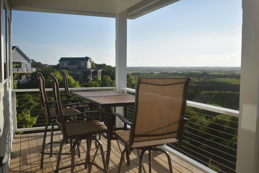 Dine outdoors on the back porch with sunset views over the peaceful sound.