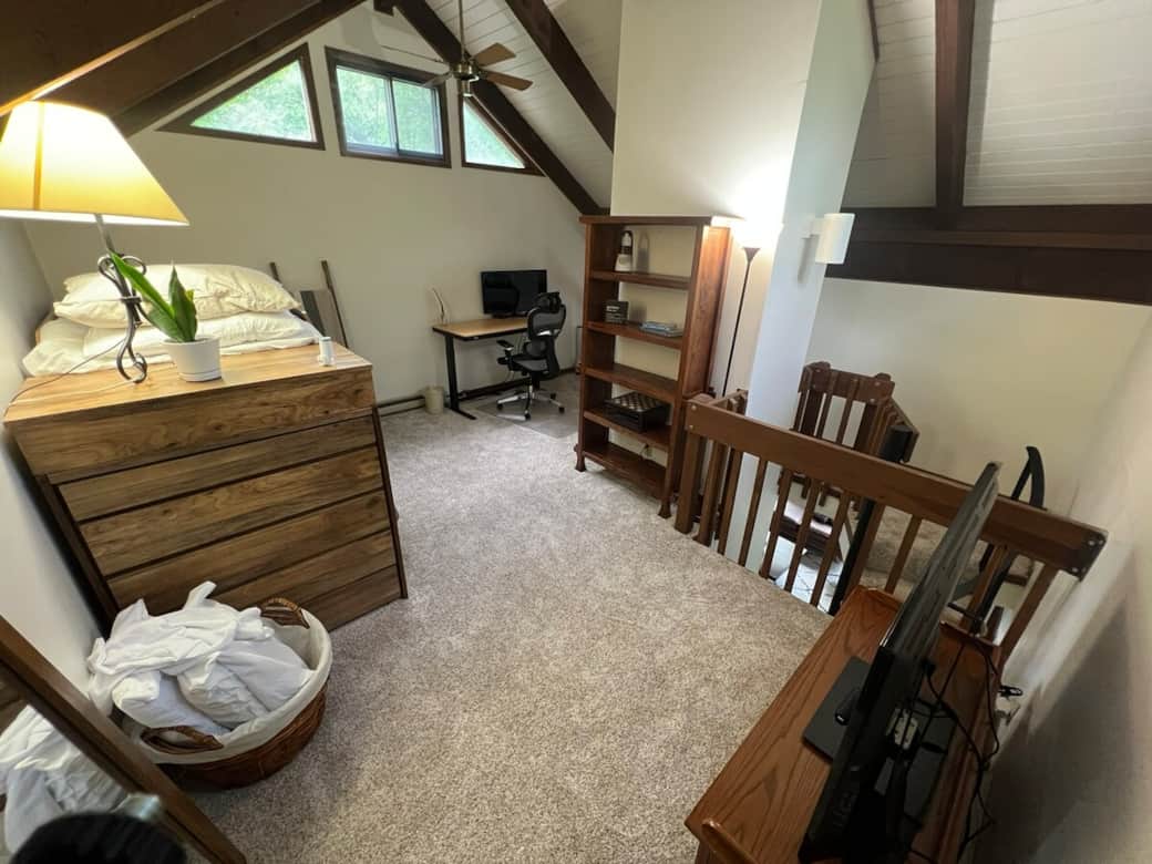Loft with twin sized bunk beds, TV, games, standing desk