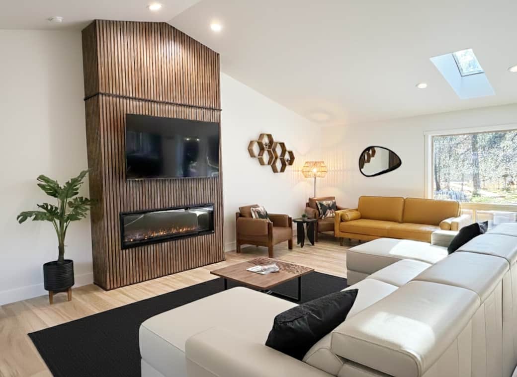 Minimalist 'Japandi' design meets cozy comfort with soaring ceilings and a feature fireplace.