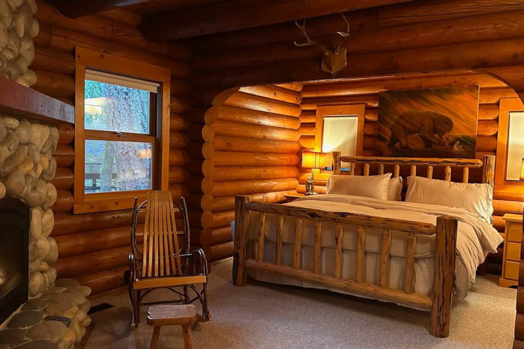 Downstairs master bedroom with gas fireplace and king size log bed 
