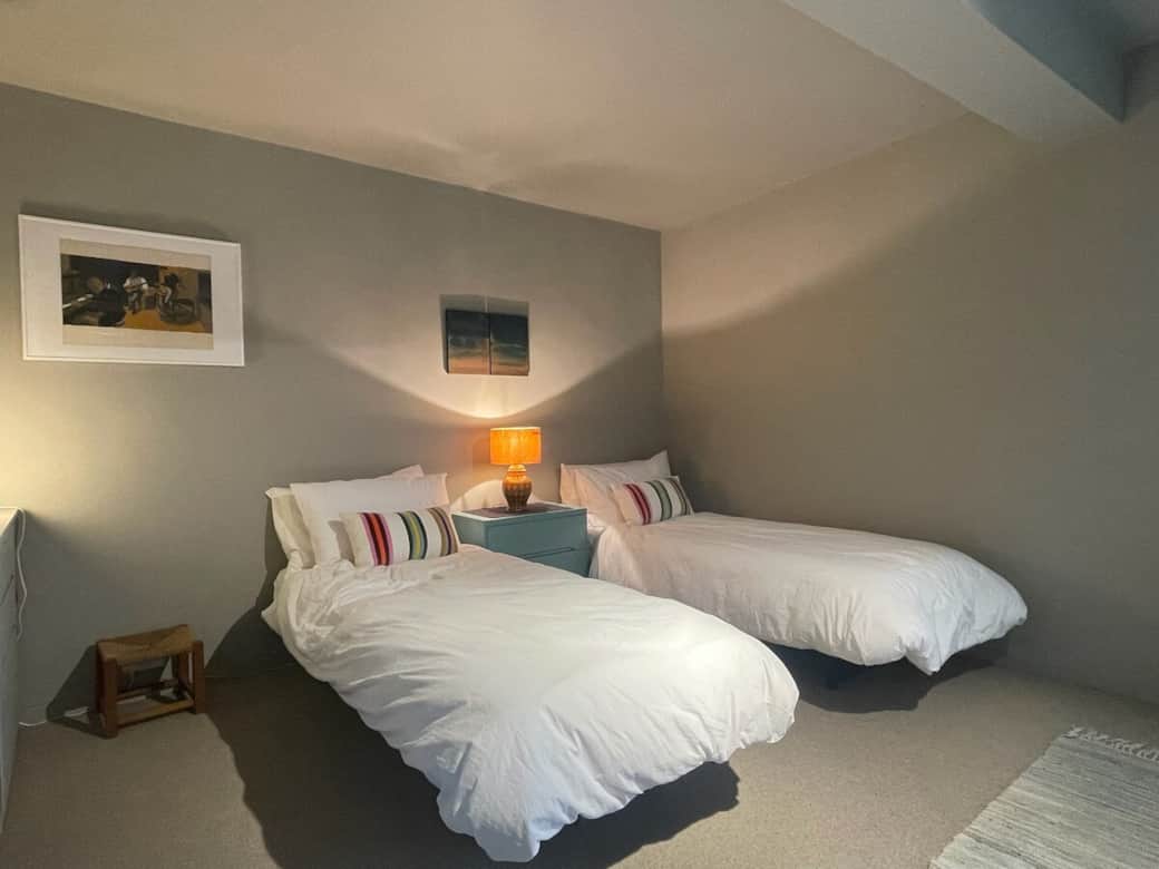 The bedroom is set up with two single beds. If required the beds can be configured to form a king size bed . The room faces west to the private front garden.