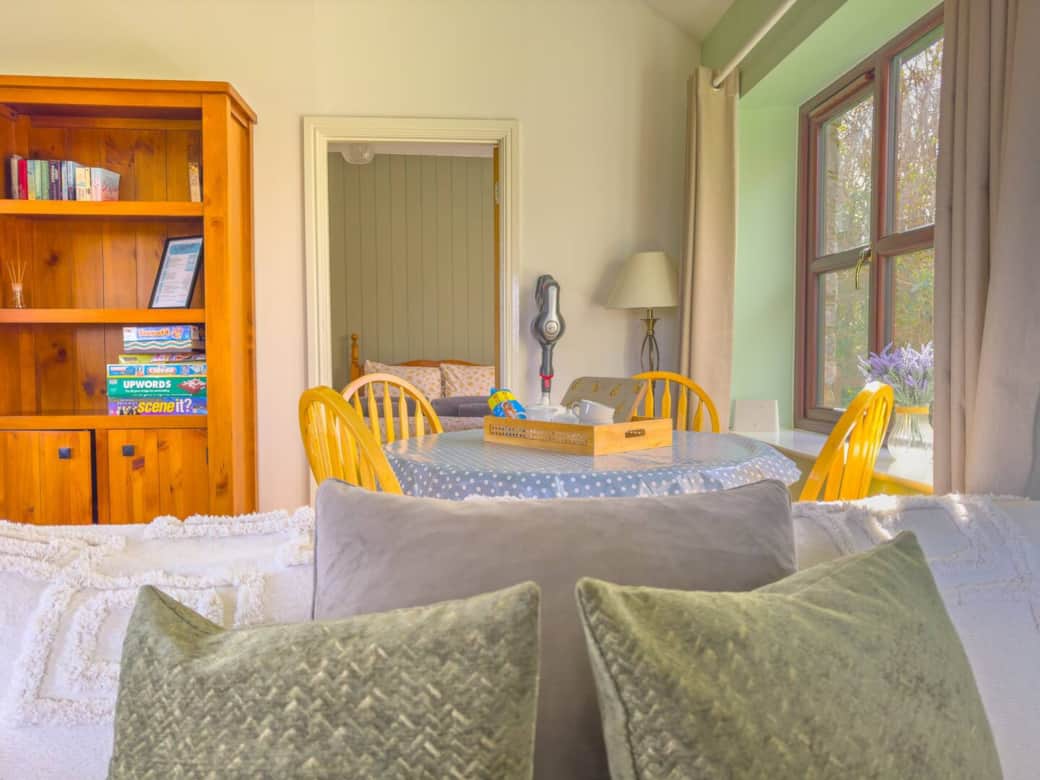 Sofa with dining area and bedroom in the background