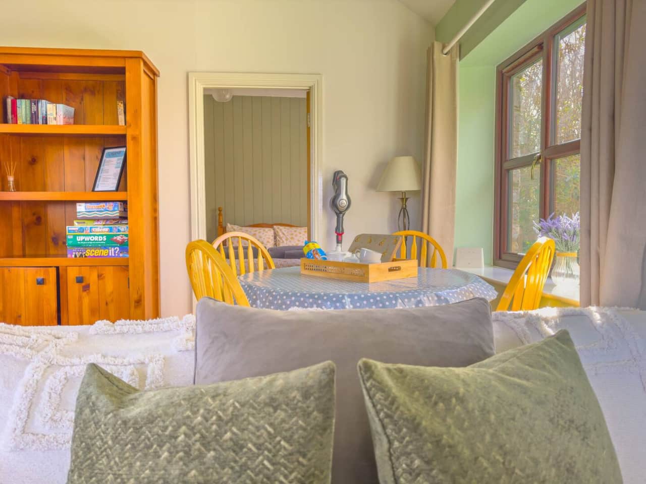 Sofa with dining area and bedroom in the background