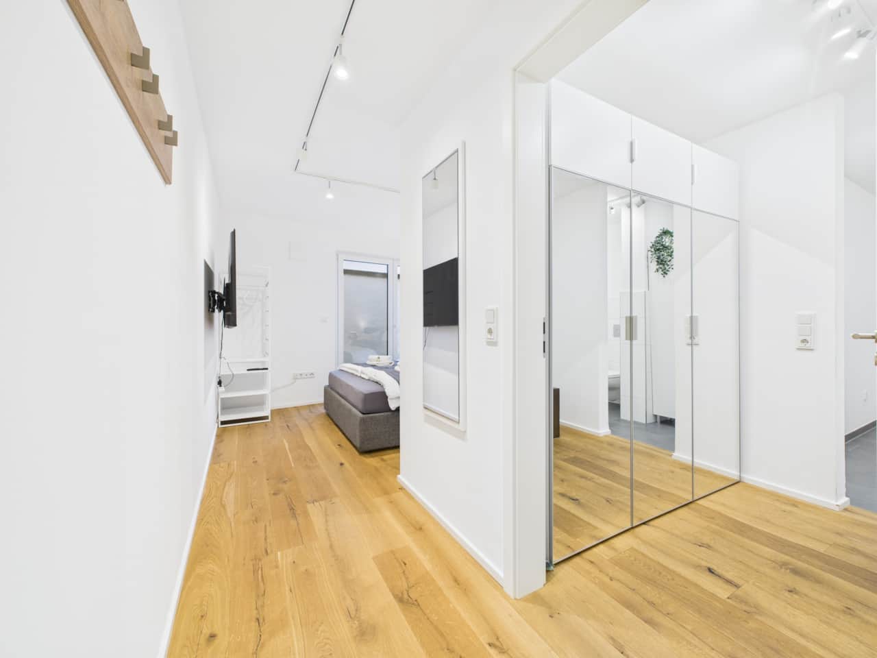 Spacious sleeping area with a modern, clear layout and an integrated dressing area.