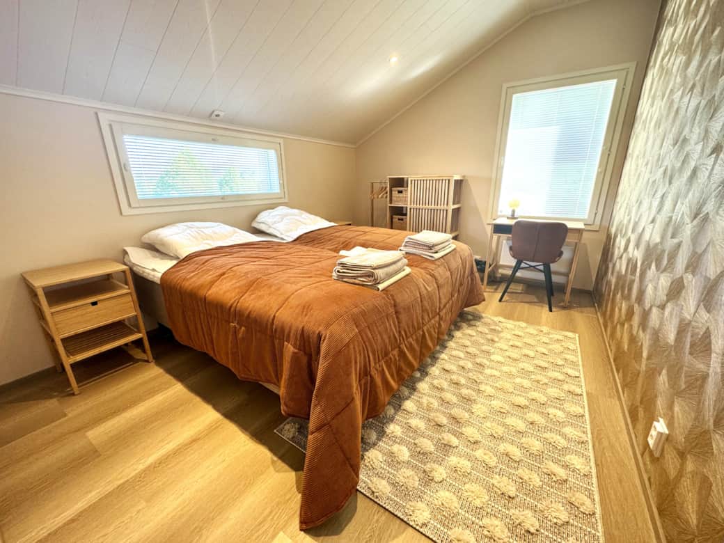 The first bedroom with a king-size bed and a wardrobe.
