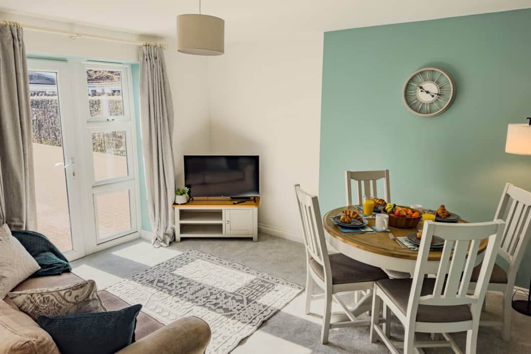 Living room with large windows & dining space