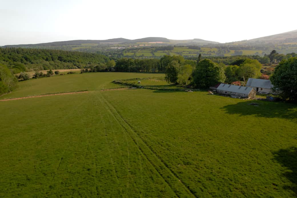 Aerial green fields farmstead wicklow hills golden hour