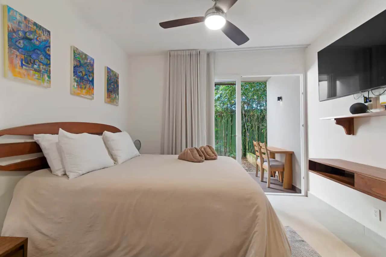 Cozy retreat: King-size bed, plush amenities, smart TV, work desk, patio. Perfect stay awaits.