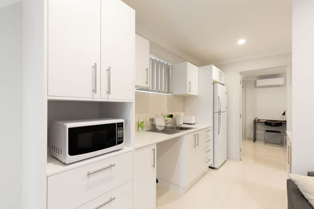 Kitchen: Sleek kitchen with ample storage, modern appliances 