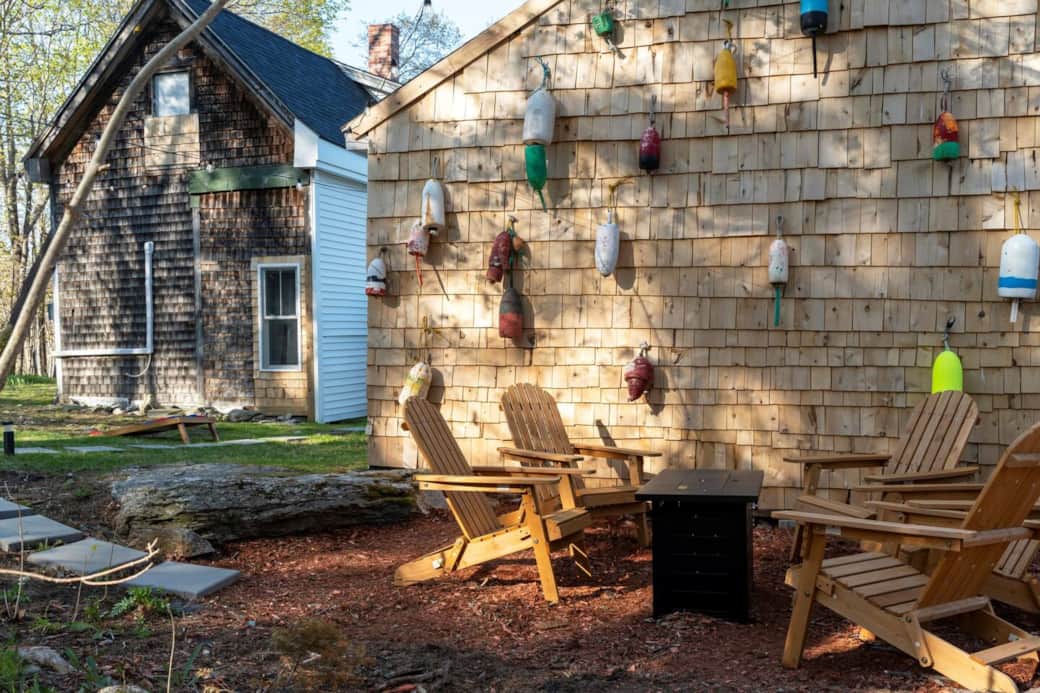Our beautiful and year round outdoor area surrounded by the trees. Enjoy the hot tub, lawn games, & propane fire pit!
