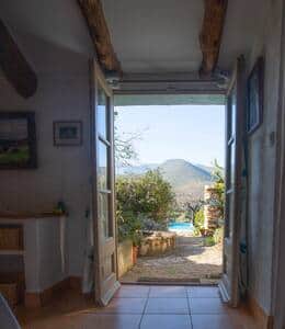 view from Kingsize bedroom through courtyard to swimming pool