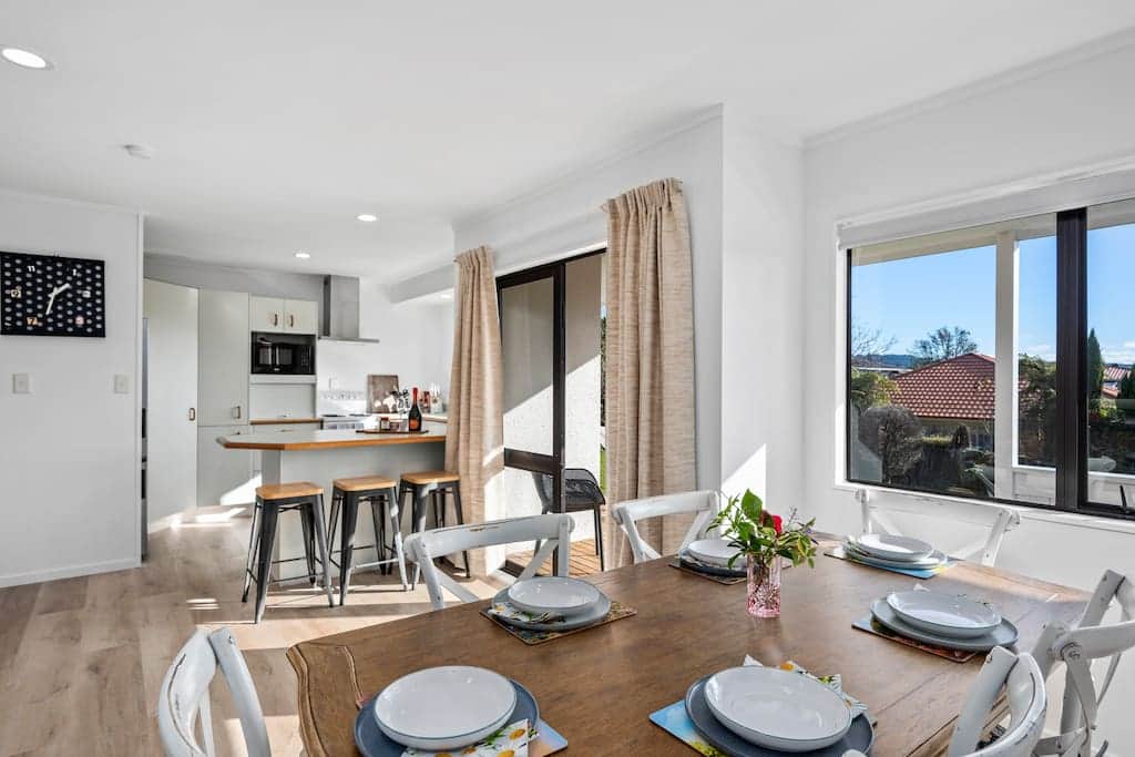 Spacious, light-filled dining area with seating for six and room for three more at the counter.
