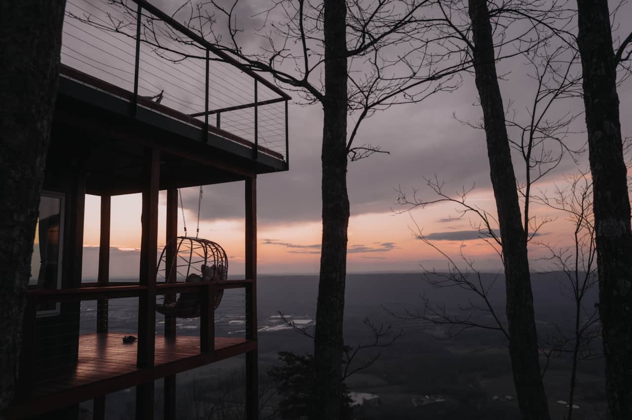The loveseat swing offers the perfect place to unwind as day turns to dusk.