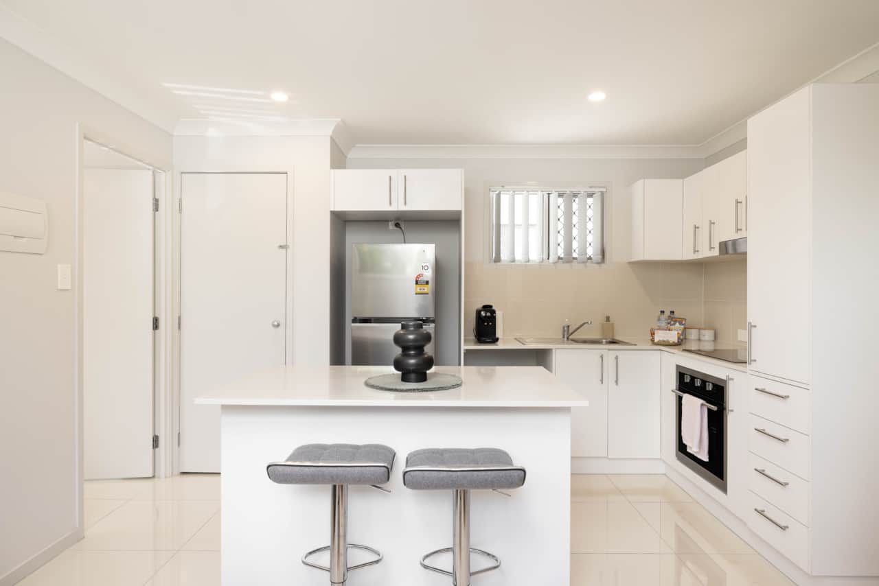 Kitchen: Sleek kitchen with ample storage, modern appliances 