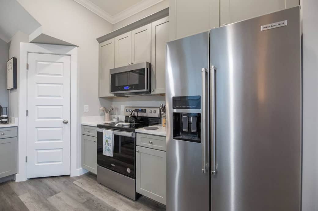 The fully equipped kitchen at The Salty Blue features sleek stainless steel appliances. 