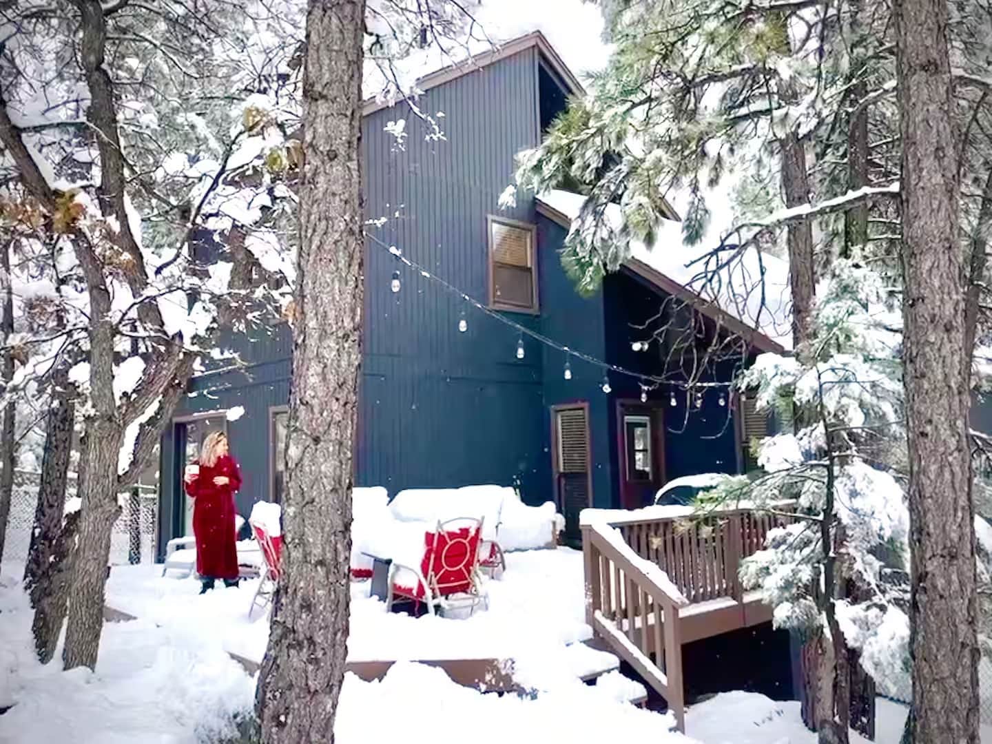 Snow-covered back exterior of mountain cabin in Munds Park