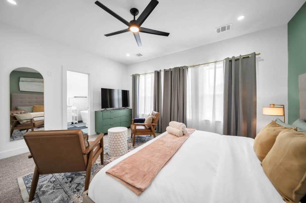 For moments of relaxation, unwind in one of the mid-century modern leather armchairs, or enjoy your favorite shows on the large flat-screen TV perched atop a sleek sage-green dresser. For moments of relaxation, unwind in one of the mid-century modern leather armchairs, or enjoy your favorite shows on the large flat-screen TV perched atop a sleek sage-green dresser.