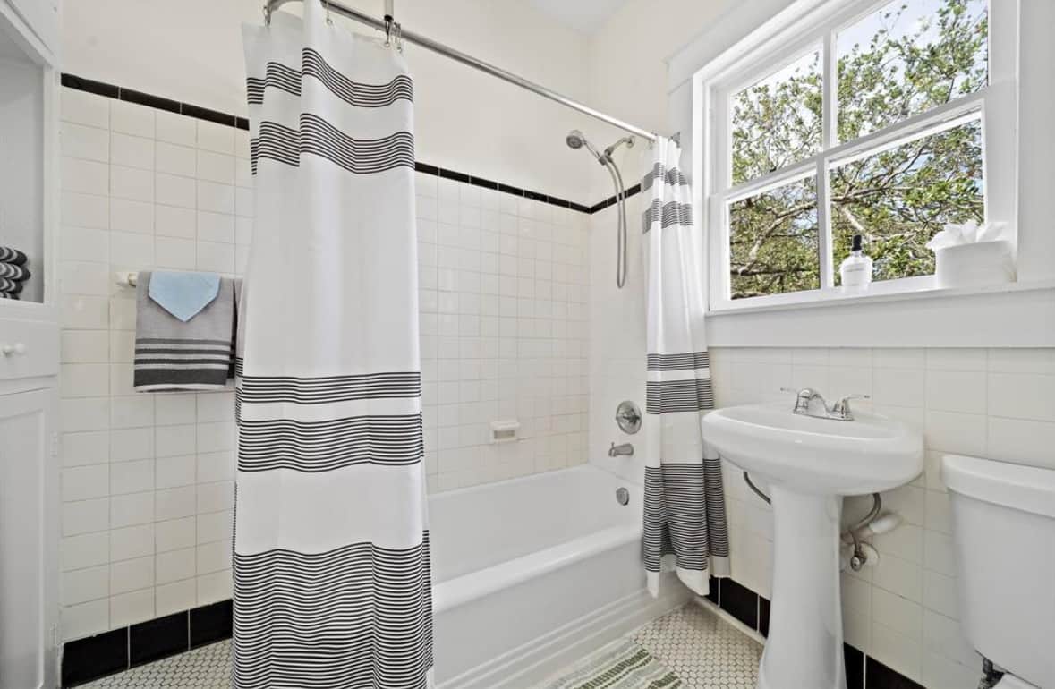 Bathroom with tub and shower at White Magnolia Galveston