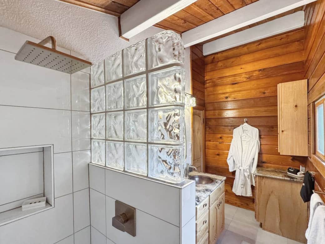 Recently remodeled, this elegant second-floor bathroom features new tile and a luxurious rainforest shower, creating a spa-like retreat. Stocked with high-quality essentials, you’ll find everything you need for a refreshing and comfortable stay. Recently remodeled, this elegant second-floor bathroom features new tile and a luxurious rainforest shower, creating a spa-like retreat. Stocked with high-quality essentials, you’ll find everything you need for a refreshing and comfortable stay.