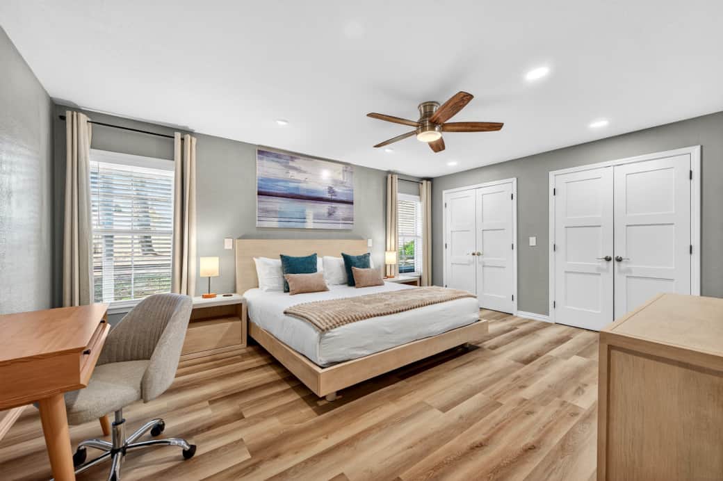 Primary bedroom with king size bed and dedicated workspace