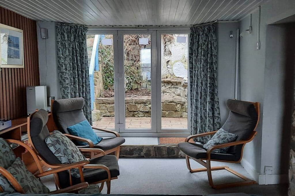 Lounge area, opposite end to the wood burner, with bifold doors out to the garden
