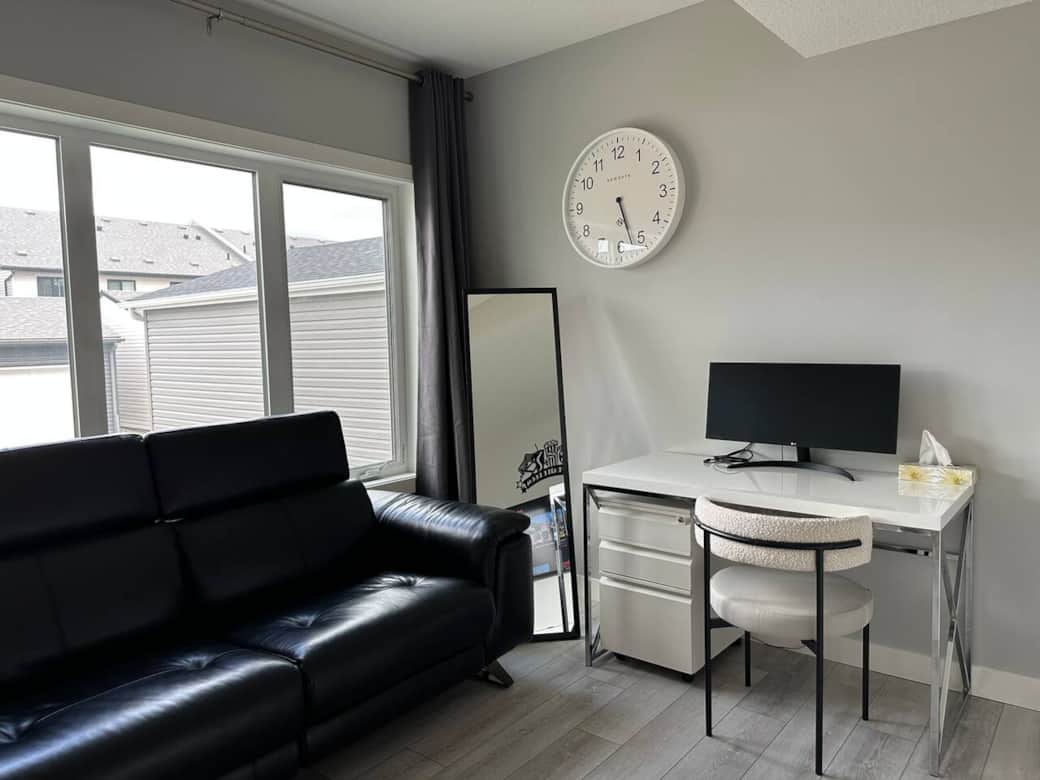 Bright and modern living space with a sleek Murphy bed, smart storage, a cozy desk setup, and comfortable seating. Perfect for relaxing, working, or enjoying a quiet night in.