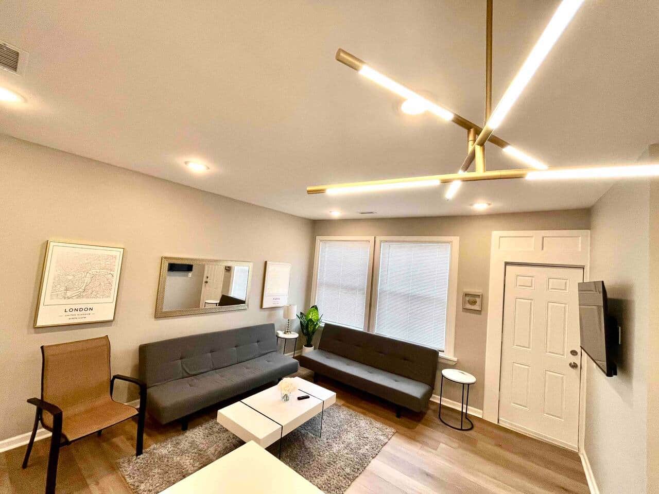 2 futon sofa beds and 50 inch tv connected to kitchen.