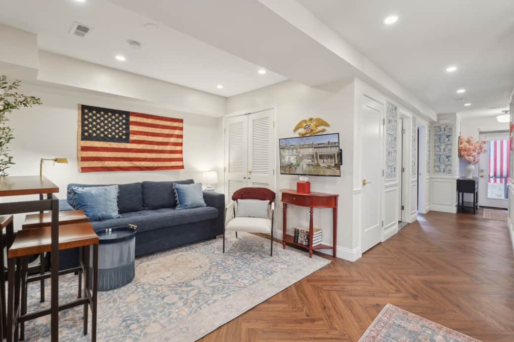 Spacious living room with smart TV, sofa bed, and open layout