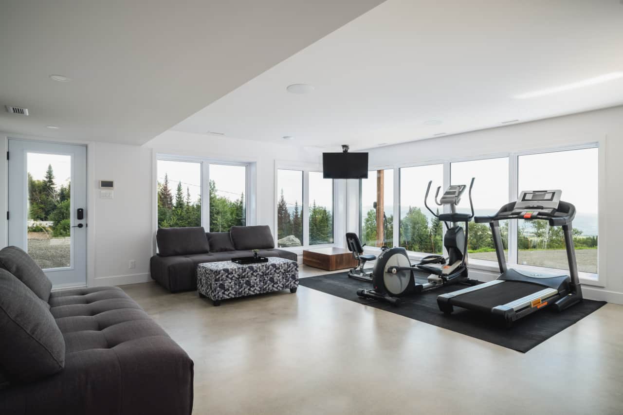 Fitness & Lounge Area – River & Mountain Views – Garden Level