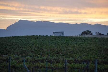 Hounds Run Vineyard Tiny House at Sunset with the Mountains in the background