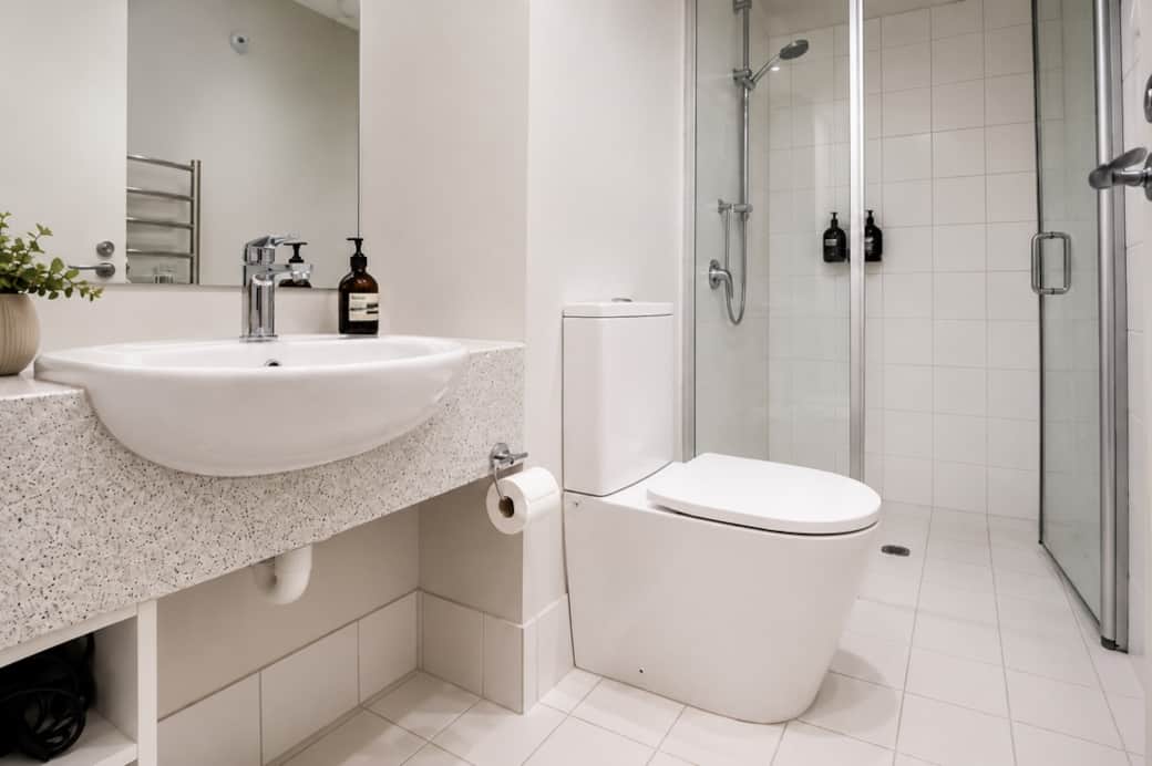 Tiled bathroom with a GHD hairdryer and everything you need to refresh.