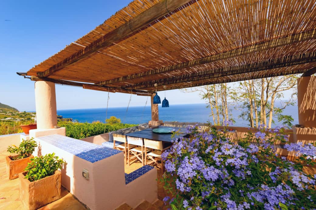 Zona pranzo esterna coperta con vista mare e giardino, perfetta per vivere l’isola all’aperto Zona pranzo esterna coperta con vista mare e giardino, perfetta per vivere l’isola all’aperto