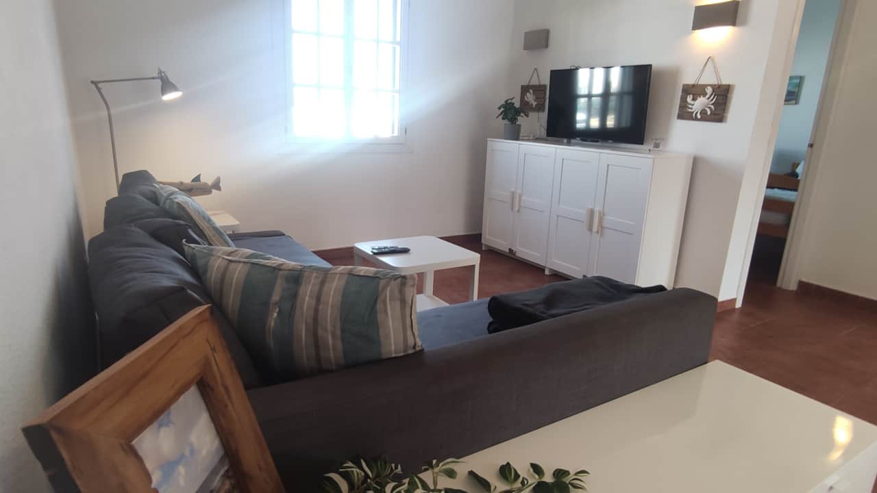 Cozy living area with smart TV and access to the terrace