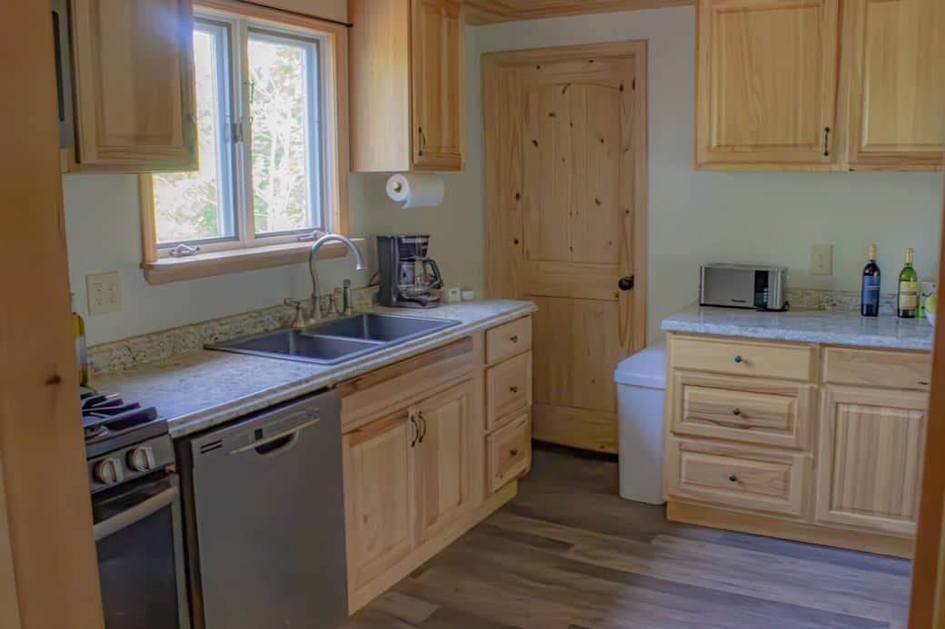 Dishwasher and a gas stove.  There are pots, pans, and utensils to prepare any meal!