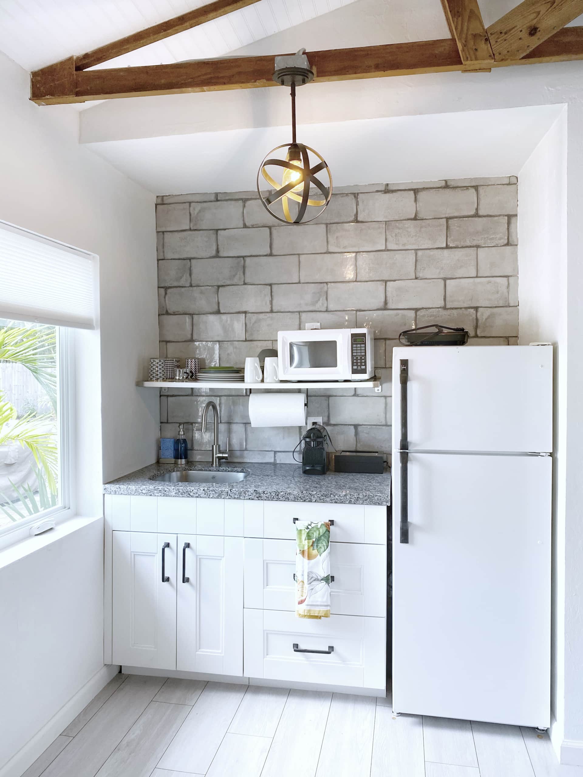 Updated kitchen in Unit 2 at Casa Citron with efficient layout, improved flow, and built-in deep drawer storage for a hot plate and toaster oven, creating a clean, open workspace.