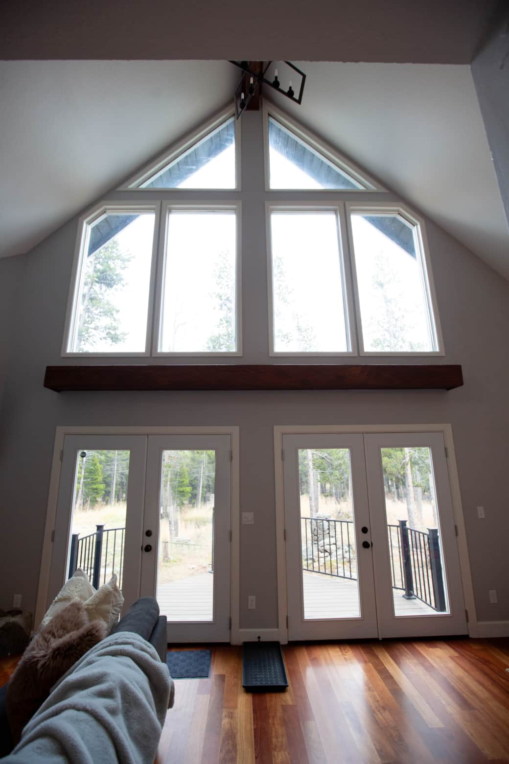Large, bright living room windows and doors with architectural interest.