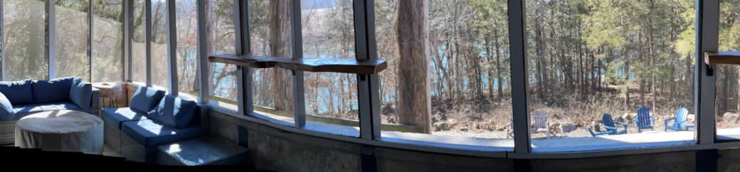 screen porch overlooks the outdoor wooded firepit