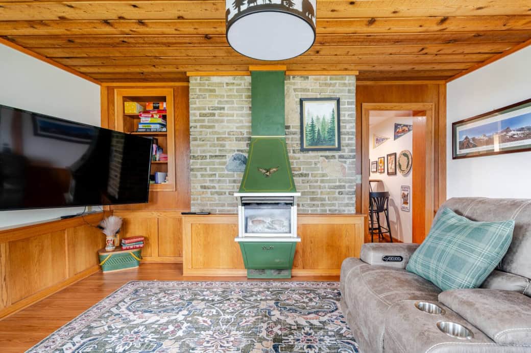 Four Seasons Room holds electric reclining chairs to (right of photo). Board games on shelving (left of photo). 65" television with Nintendo Switch (not in photo). Decorative fireplace and the woodpaneling make this room our favorite! Four Seasons Room holds electric reclining chairs to (right of photo). Board games on shelving (left of photo). 65" television with Nintendo Switch (not in photo). Decorative fireplace and the woodpaneling make this room our favorite!
