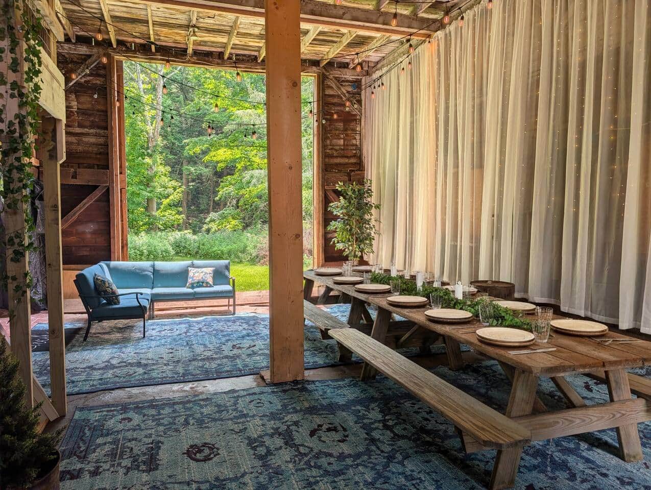 The barn door/wall slides open. The creek is just beyond the greenery in the background. (Table top setting generated by AI).