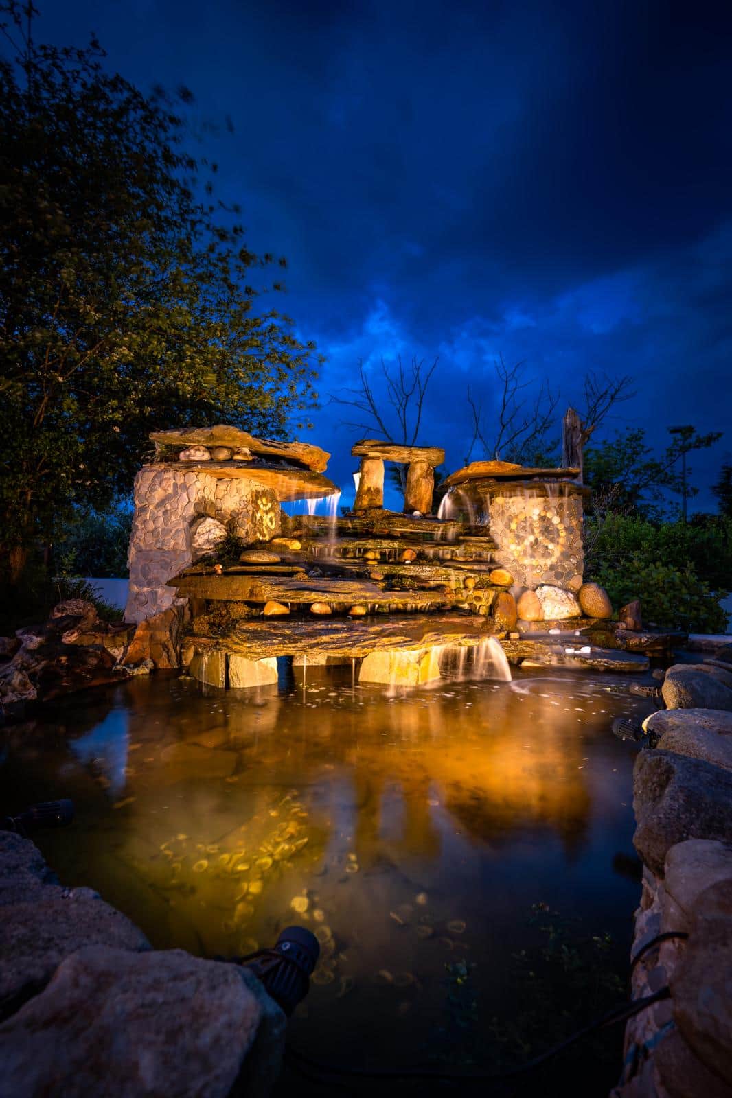Enchanting gardens with waterfall at night at The Hideaway Muff in Donegal